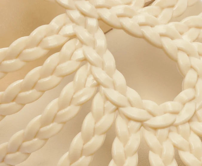 Flat sandal with braided straps, white teardrop shape.