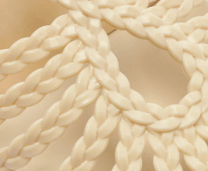 Flat sandal with braided straps, white teardrop shape.