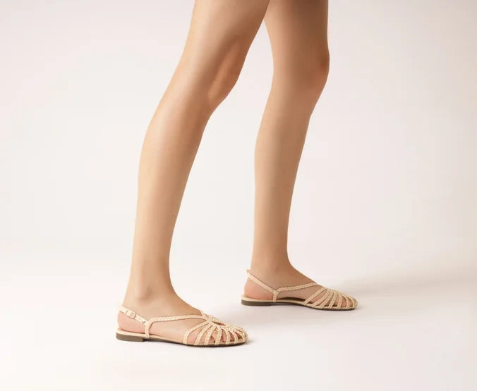 Flat sandal with braided straps, white teardrop shape.